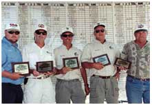 Fishing tournament winners holding their awards