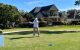 A golfer swings a club at the St. Jude Houston Golf Classic. 
